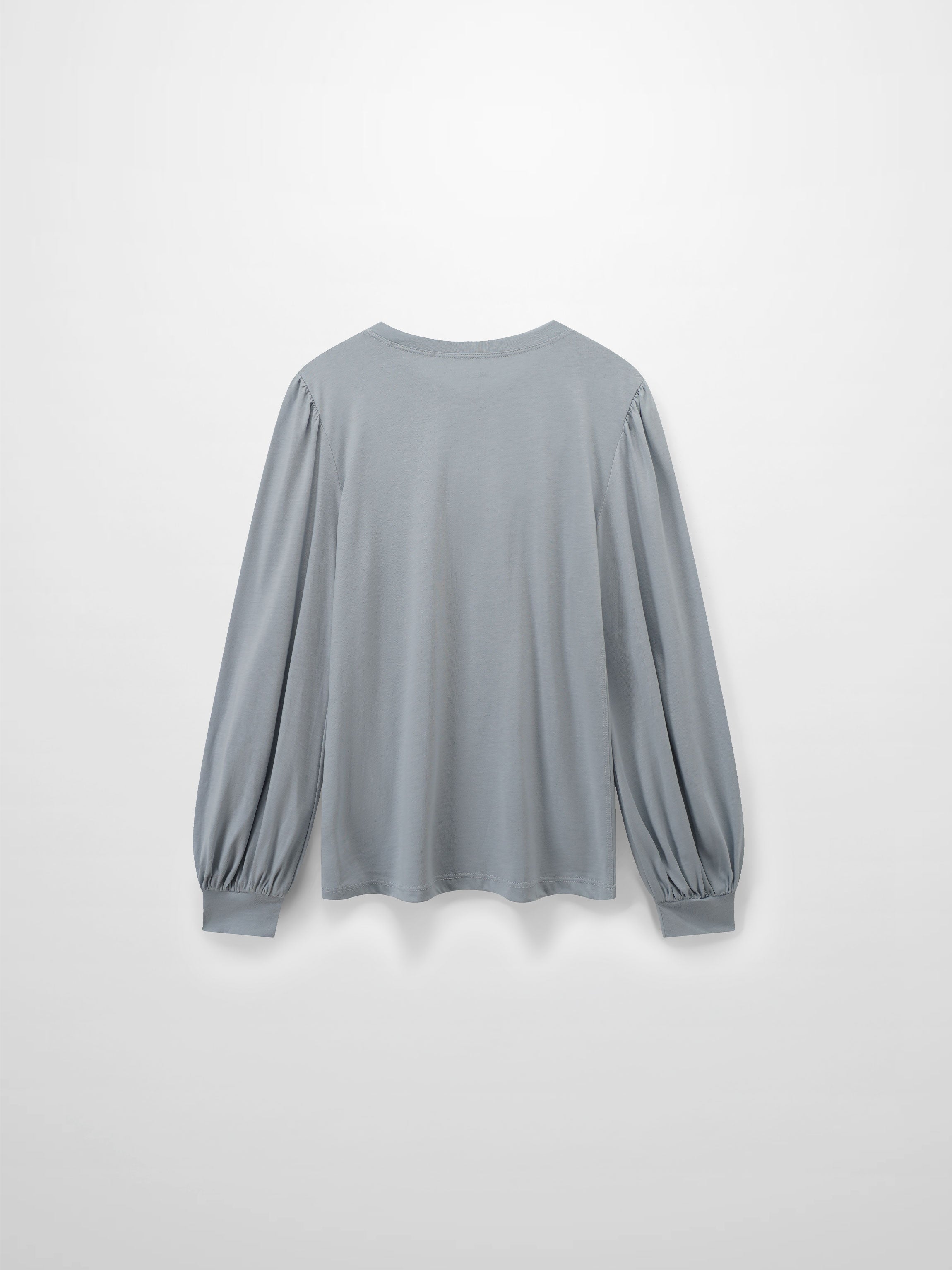 A full, back view of the light gray, long-sleeved shirt. The distinctive puffed shoulders and voluminous, gathered sleeves are also visible from behind.