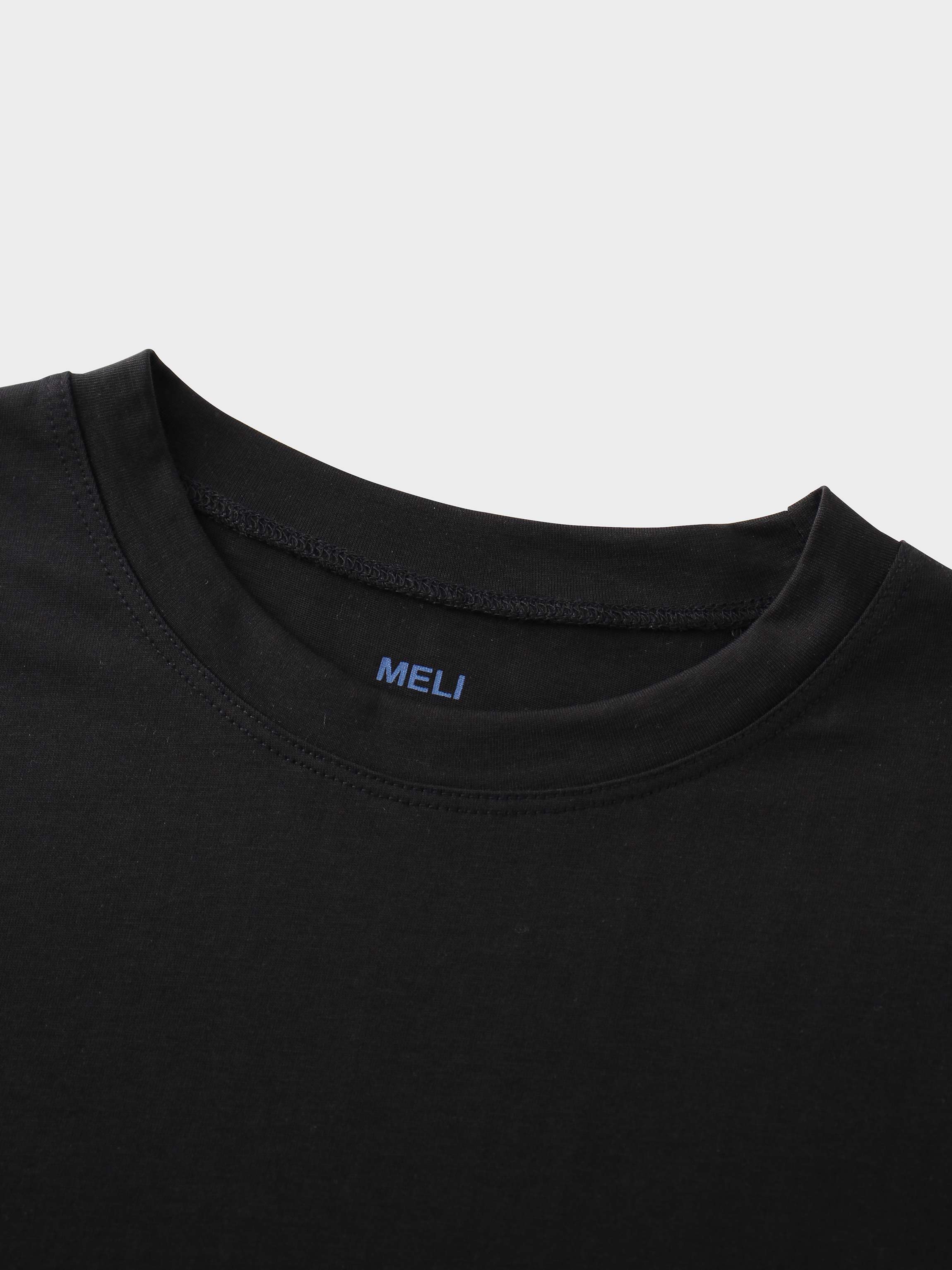 A close-up of the crewneck collar of the black t-shirt. On the inside, the brand name "MELI" is printed directly onto the fabric in blue.