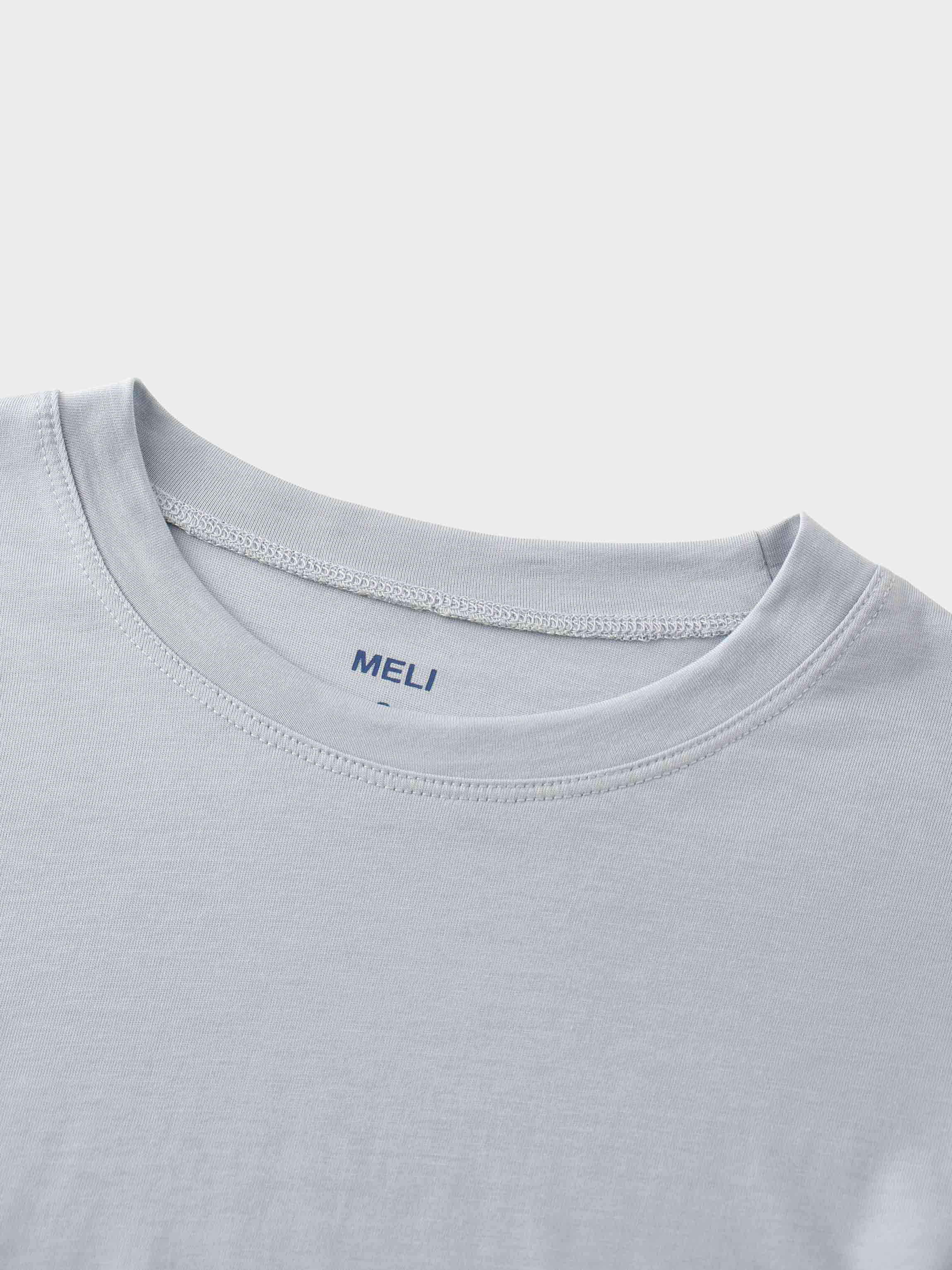 A close-up of the crewneck collar of the light gray t-shirt. On the inside, the brand name "MELI" is printed directly onto the fabric in blue.