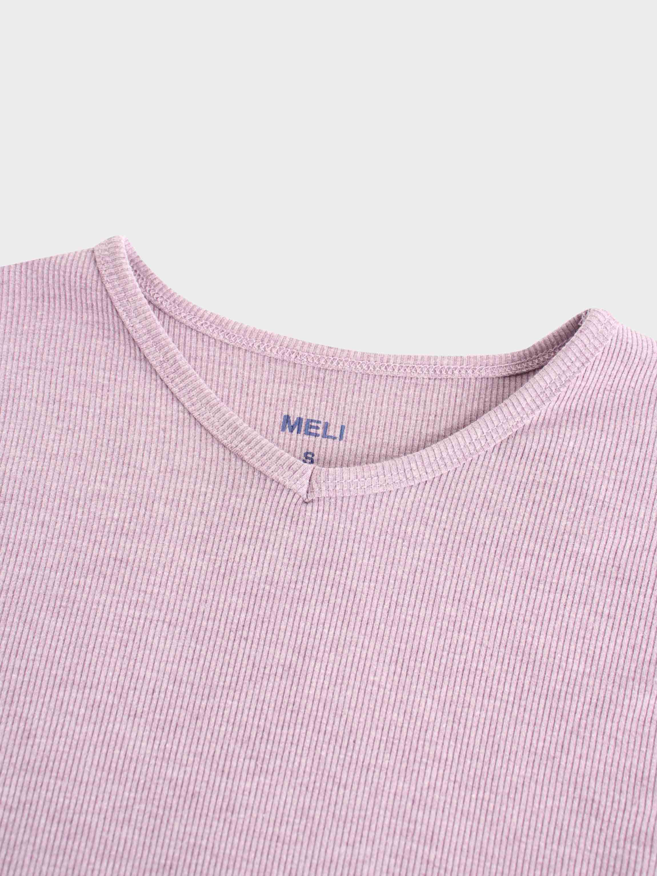 A close-up of the notched neckline on the lavender ribbed shirt. A tag printed in blue on the inside reads "MELI" with the size "S" below it.
