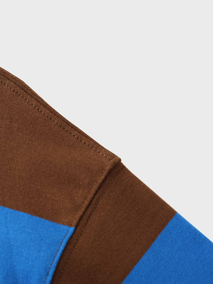 Seams of a blue and brown striped fabric.