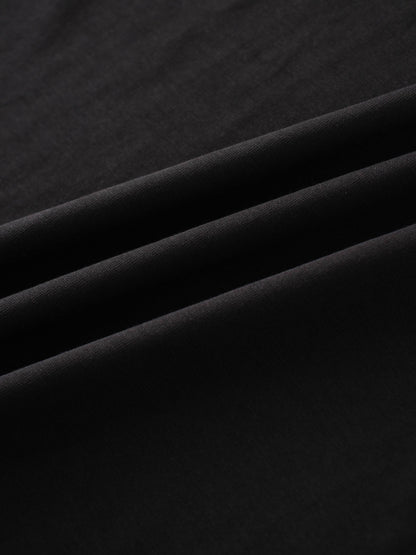 This is a detailed shot of a soft, black textile, showing its gentle folds and smooth, matte finish.