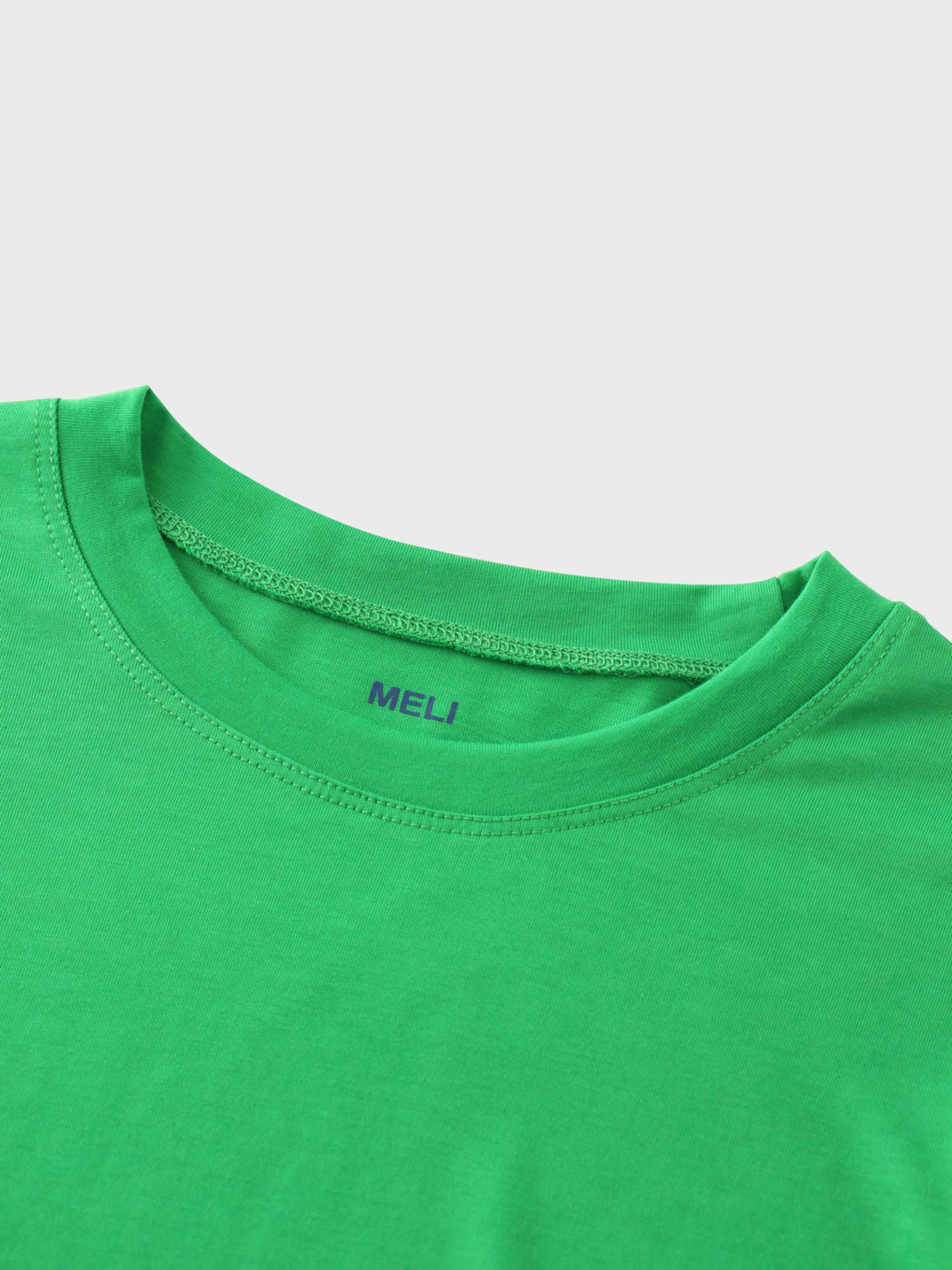 A close-up of the crewneck collar of the vibrant green t-shirt. On the inside, the brand name &quot;MELI&quot; is printed directly onto the fabric in blue.