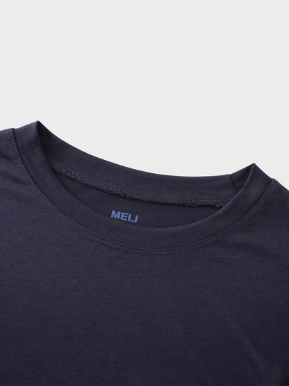 A close-up of the crewneck collar of the dark purple t-shirt. On the inside, the brand name "MELI" is printed directly onto the fabric in blue.