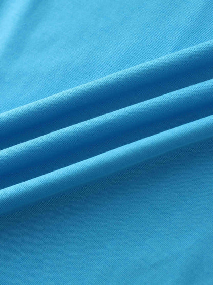 A close-up of a smooth fabric in a vibrant, bright blue color. The material is gathered into soft, diagonal folds.