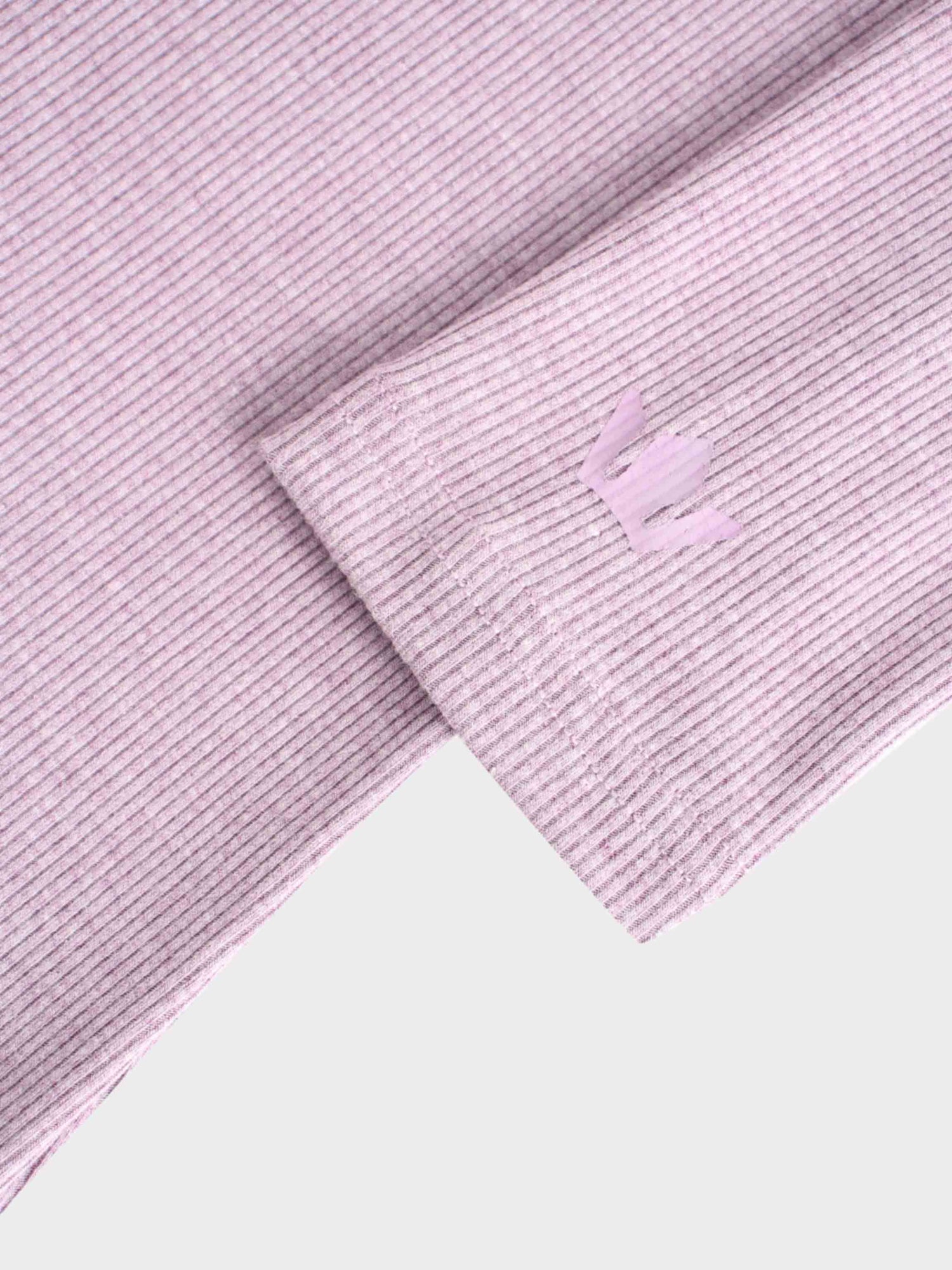 A close-up of the sleeve cuff of the light purple, ribbed garment. It features a subtle, tone-on-tone logo pressed into the fabric near the hem.